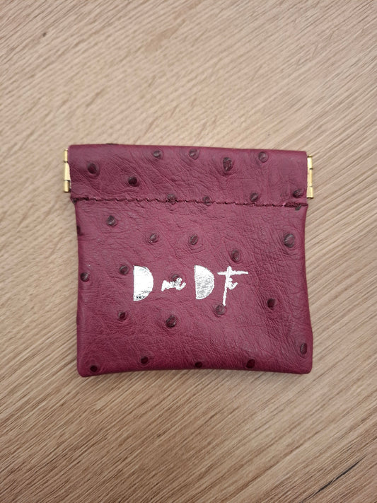 Monedero fleje piel berenjena estampado avestruz